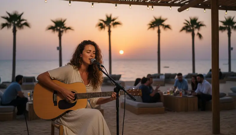 Singer playing acoustic guitar at a relaxed beach club event in Dubai